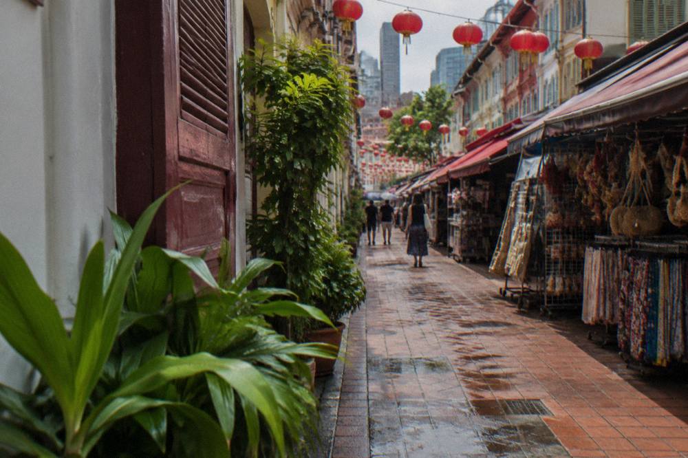 Street market stalls and shophouses on a Chinatown street in Singapore
