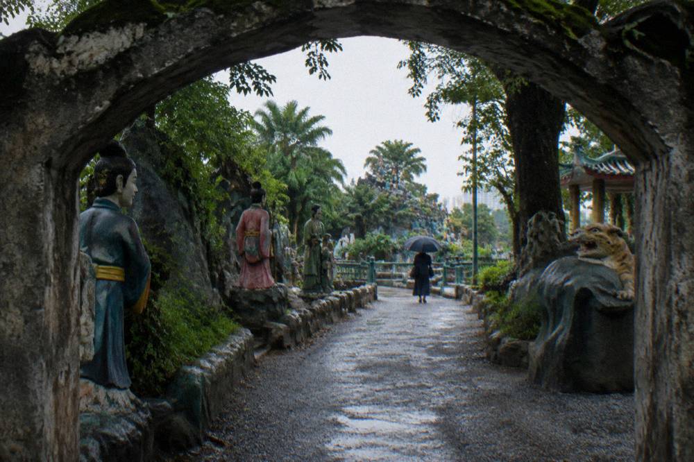 Entrance area of a Singapore theme park with statues beside a pathway