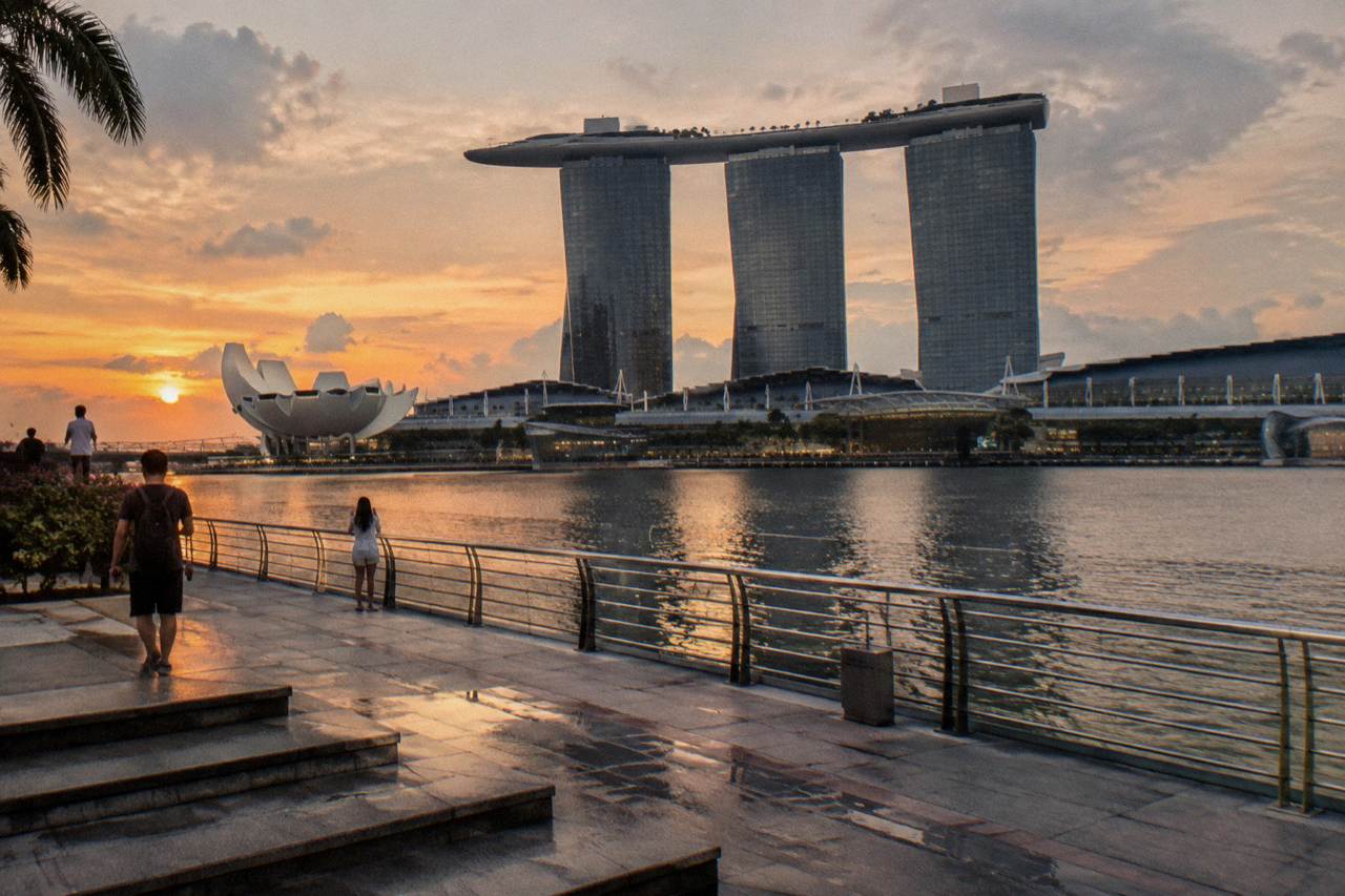 Marina Bay waterfront promenade with the three Marina Bay Sands towers and the bay skyline