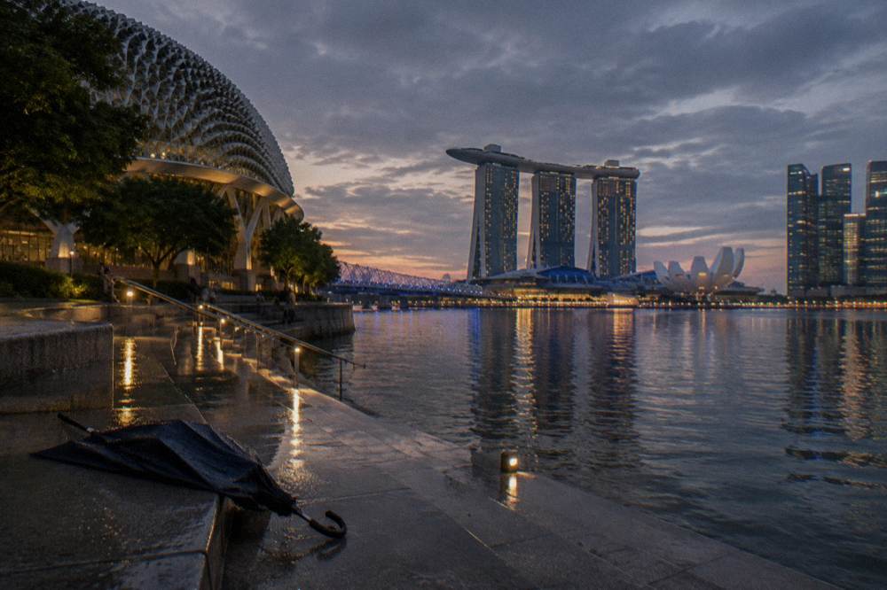 Waterfront skyline of Marina Bay seen across the water at dusk