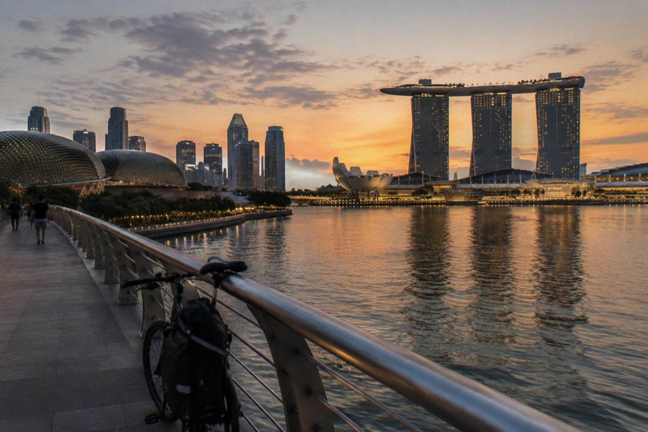 Singapore skyline across Marina Bay at dusk with lit towers along the waterfront