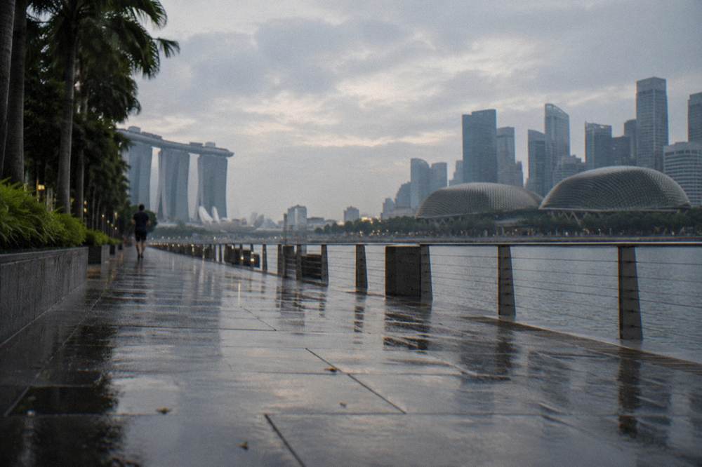 Waterfront promenade at Marina Bay with the city skyline behind it