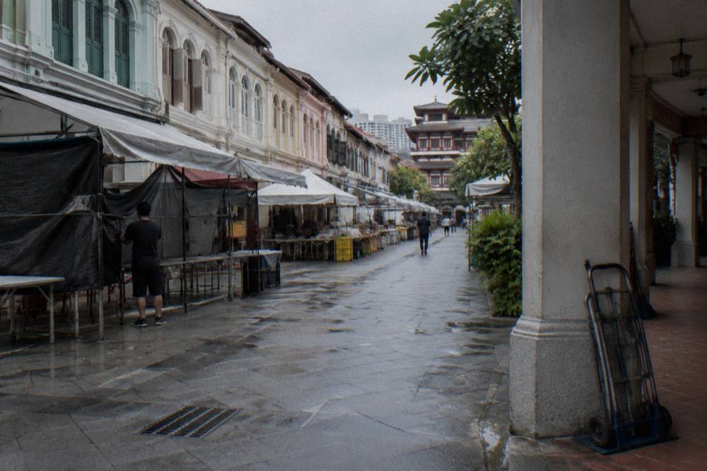 Market stalls and restored shophouses on a pedestrian street in Chinatown