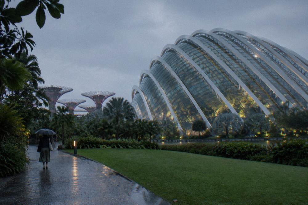 Glass conservatory building beside outdoor lawns at Gardens by the Bay
