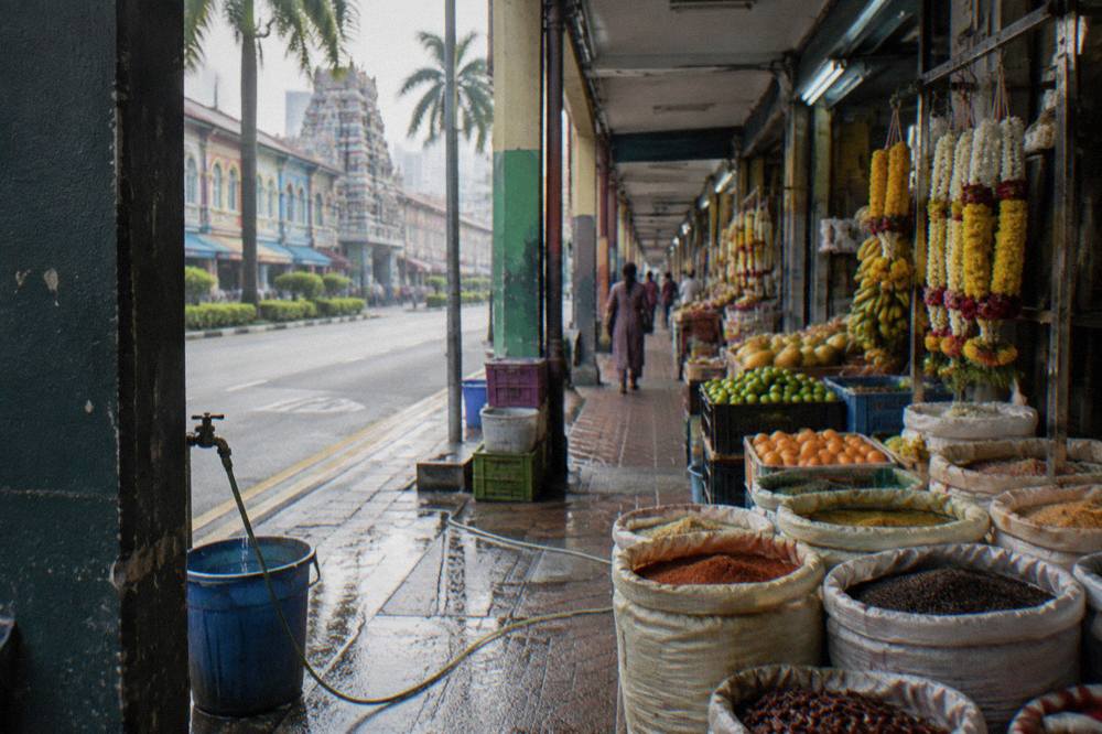 Market stalls and shophouses along a street in Little India Singapore