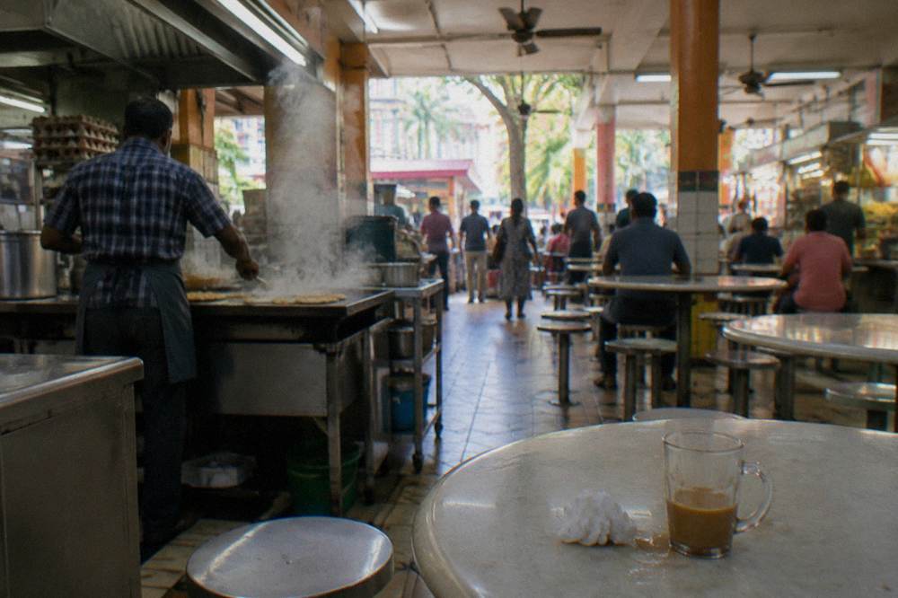 Hawker centre food stalls with covered seating rows in Singapore