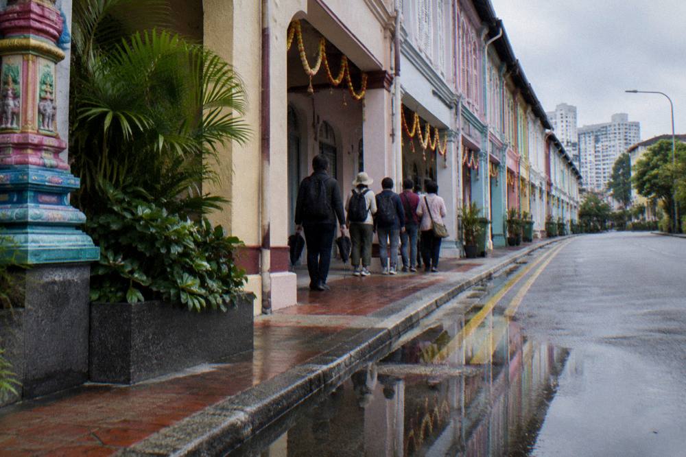 Guided walking group gathered on a market street in Little India Singapore